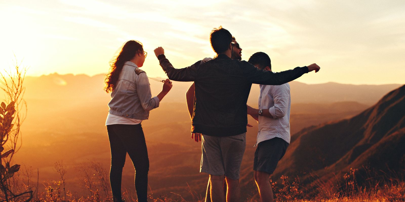4 students standing on top of a mountain