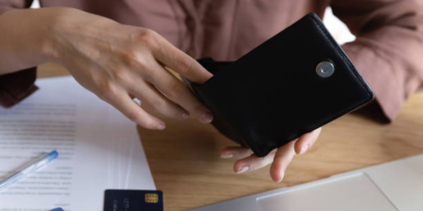 Female hands hold wallet looks empty