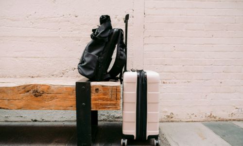 a piece of luggage sitting on top of a wooden bench