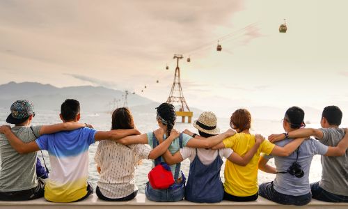 People sitting on a wall, showing how to make friends.