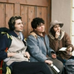A group of gap year travelers sitting next to each other.