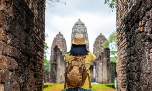 Traveler exploring ancient temple during Asia gap year.