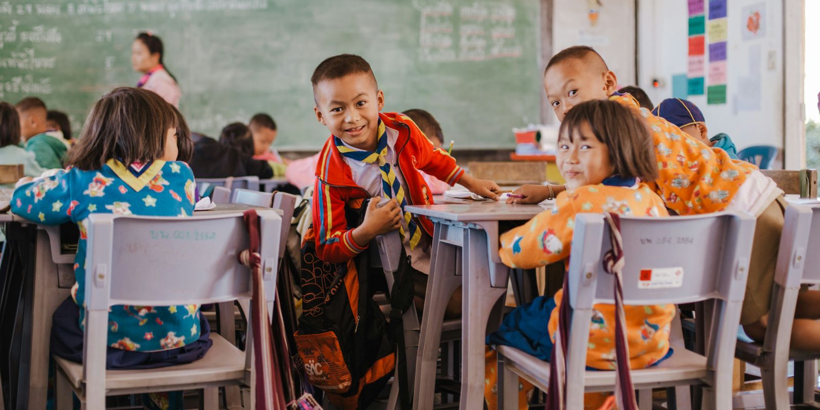 Thai students smiling in a colorful classroom in Thailand
