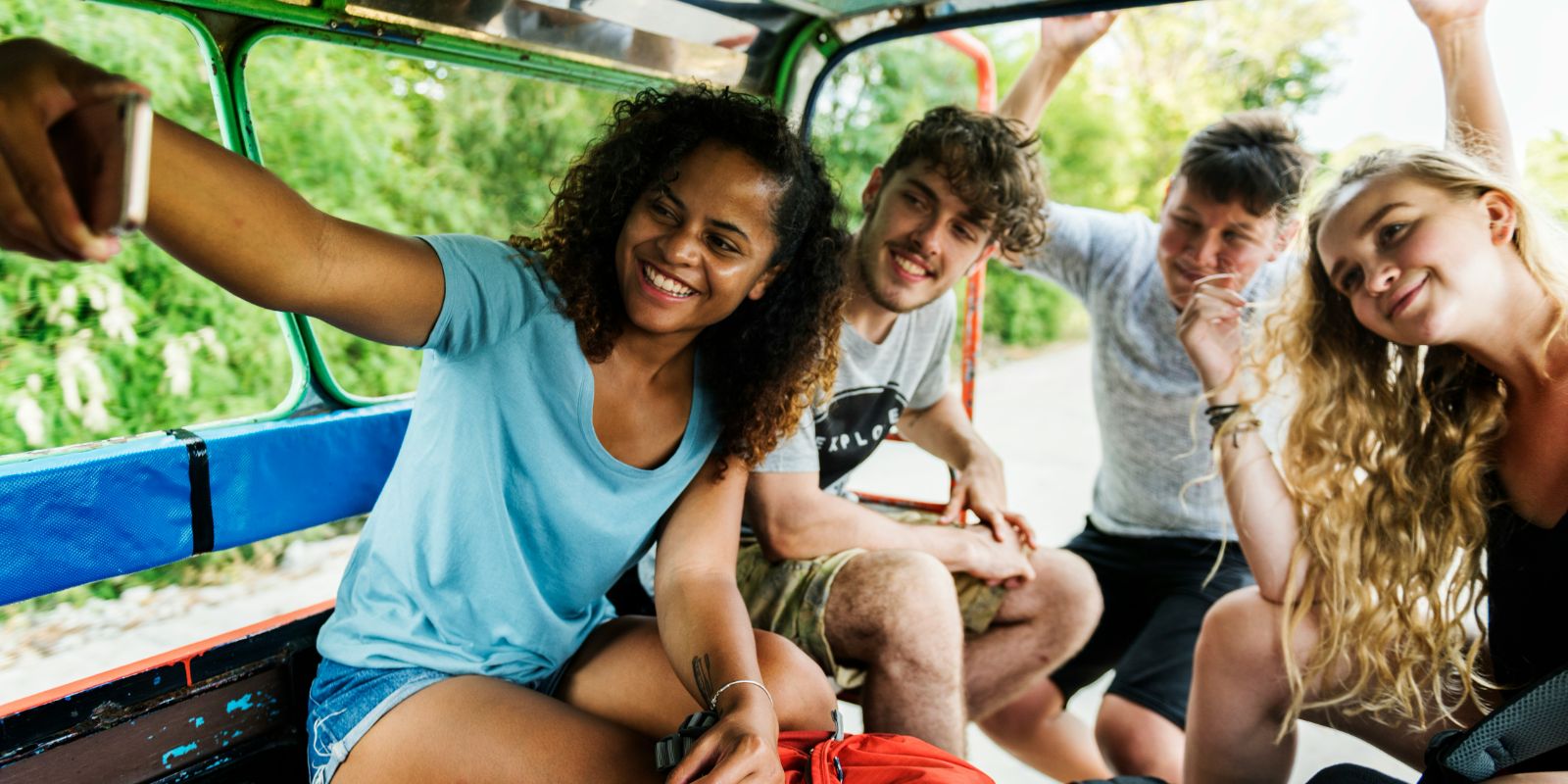 Group of happy young travelers taking a selfie during their gap year adventure.